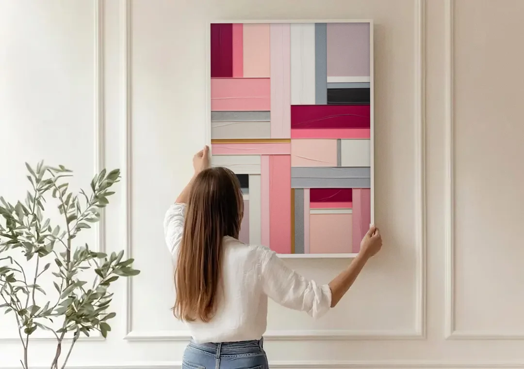 Geometric Elegance Pink Abstract canvas wall art being hung on a paneled wall