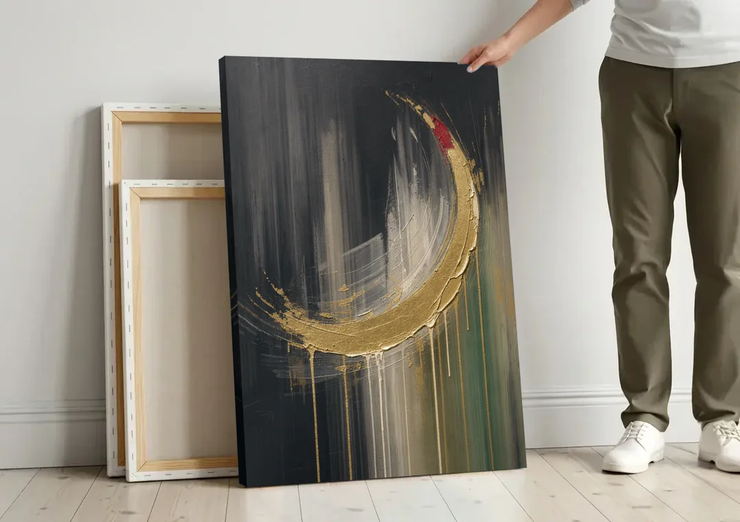Gold Abstract Crimson-Tipped Crescent canvas wall art leaning against a wall next to blank canvases
