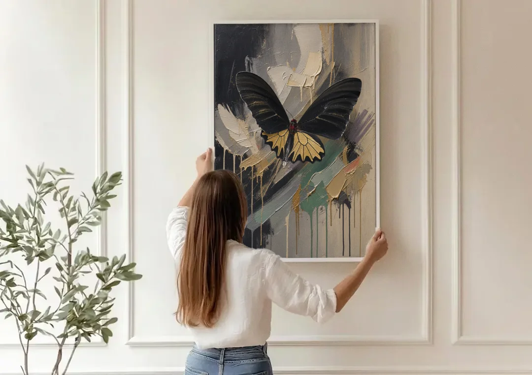 Gold Butterfly Wall Art of a Birdwing on Charcoal canvas wall art being hung on a paneled wall