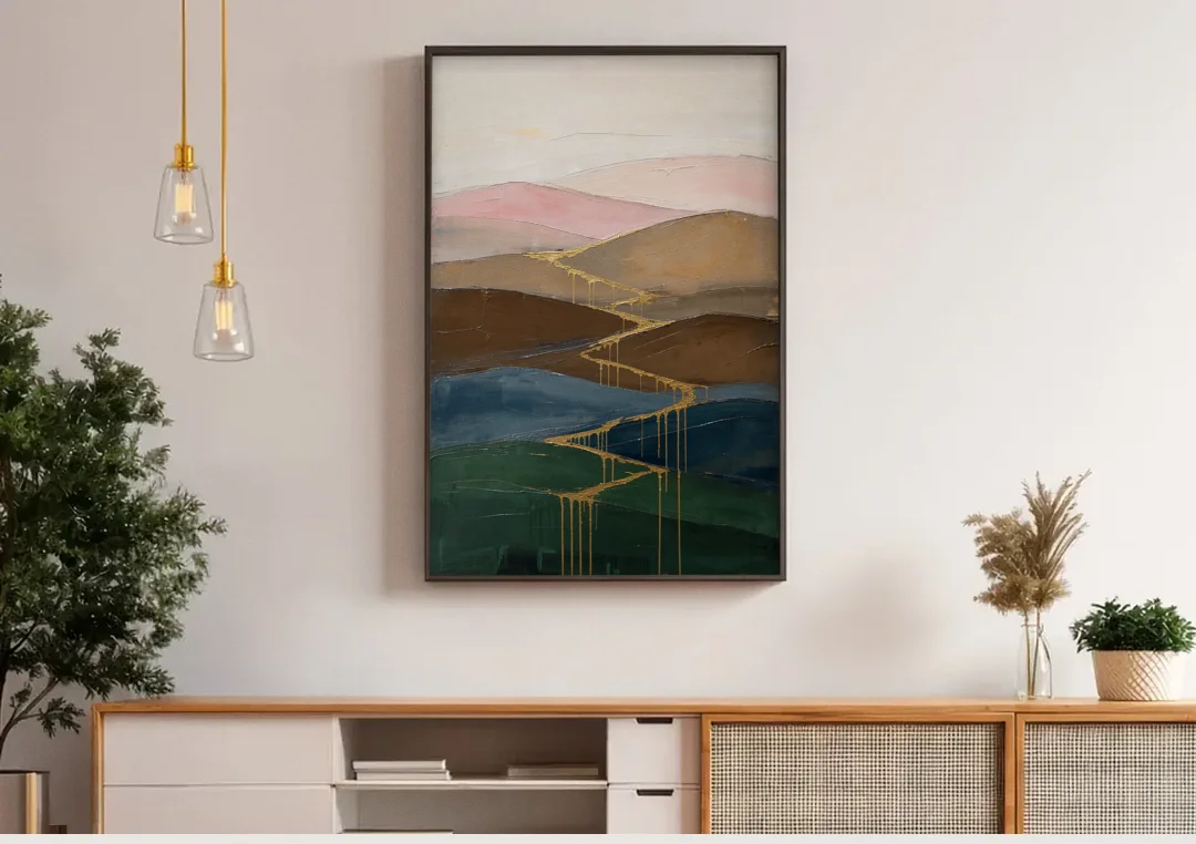 Gold Drip Stream Through Layered Hills canvas wall art above a wooden sideboard under pendant lights