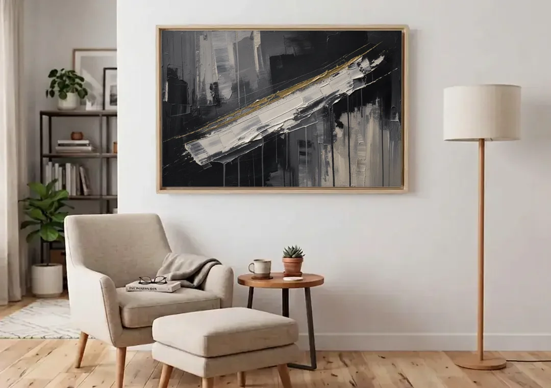 Gold-Edged White Sweep in Black and White canvas wall art above an armchair in a bright living room