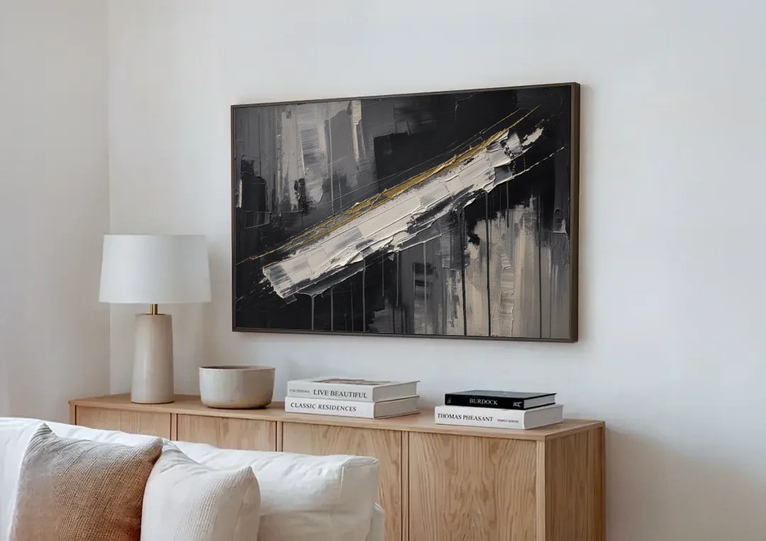 Gold-Edged White Sweep in Black and White canvas wall art above a wooden sideboard next to a sofa