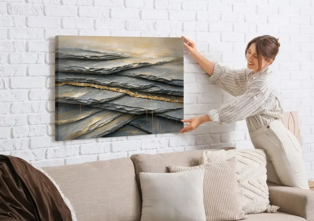 Gold Leaf Abstract Painting of Slate Seams canvas wall art being hung on a white brick wall above a sofa