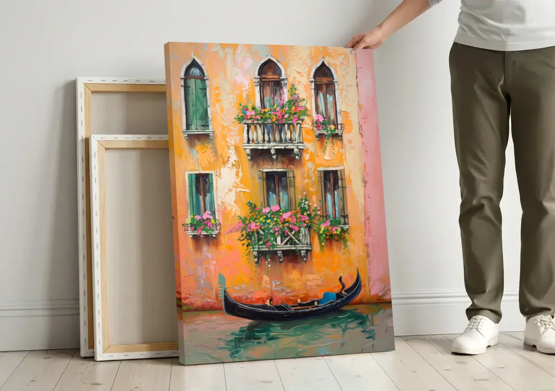 Gondola Painting Under Flowered Windows canvas wall art leaning against a wall next to blank canvases