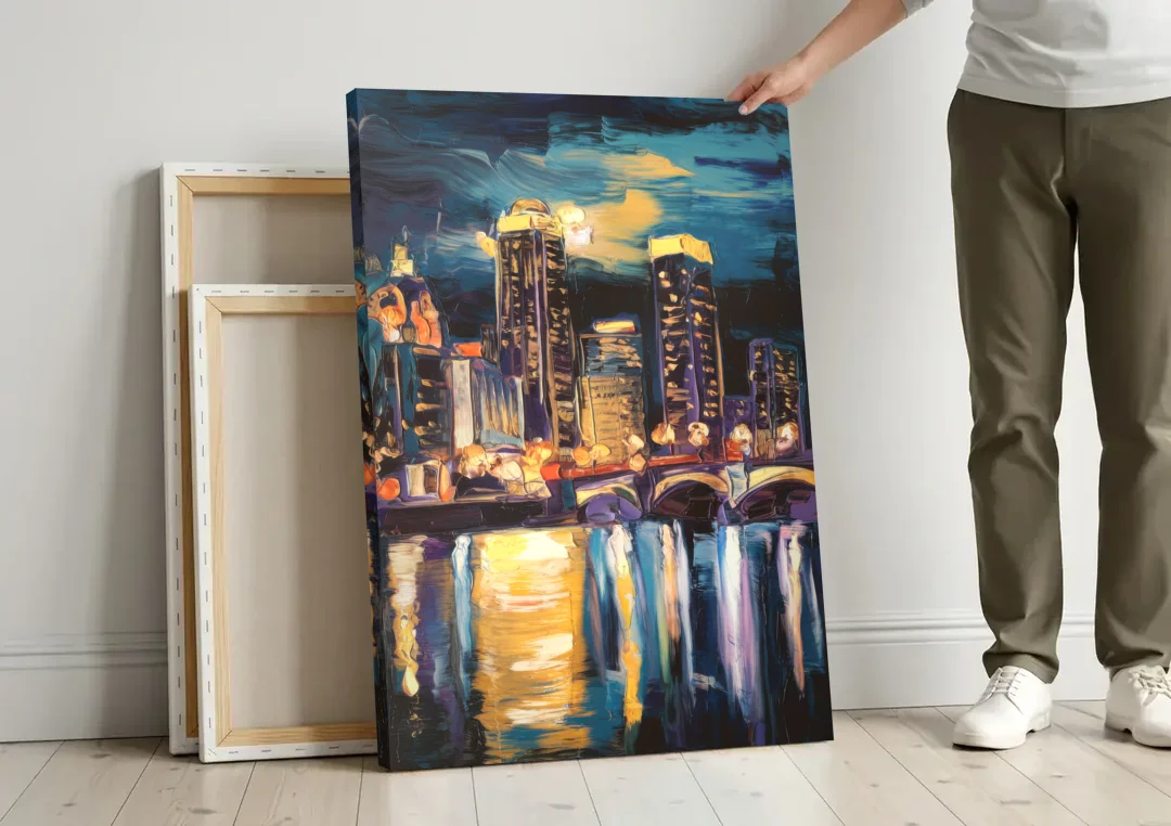 Grand Rapids Nighttime Skyline Glow canvas wall art leaning against a wall next to blank canvases