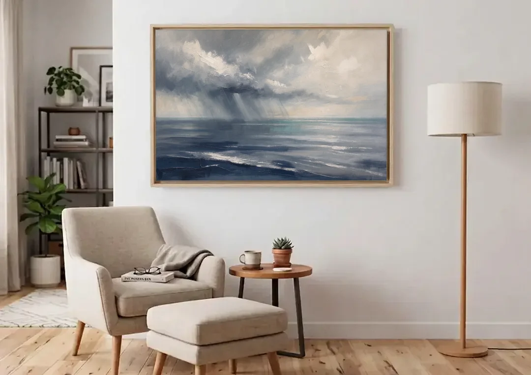 Gray and Blue Wall Art of a Sea Squall canvas wall art above an armchair in a bright living room