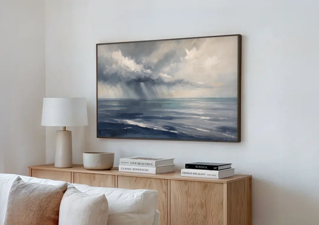 Gray and Blue Wall Art of a Sea Squall canvas wall art above a wooden sideboard next to a sofa