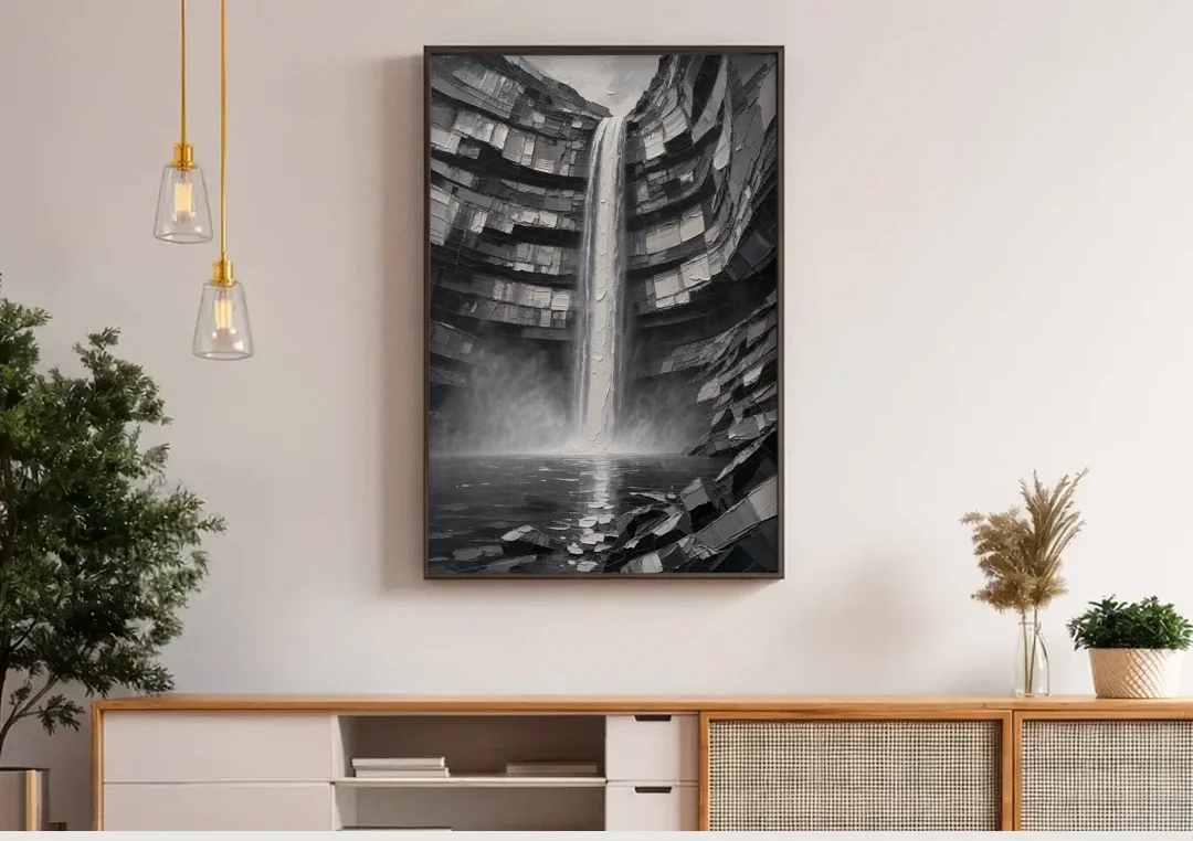 Grayscale Wall Art of a Canyon Waterfall canvas wall art above a wooden sideboard under pendant lights