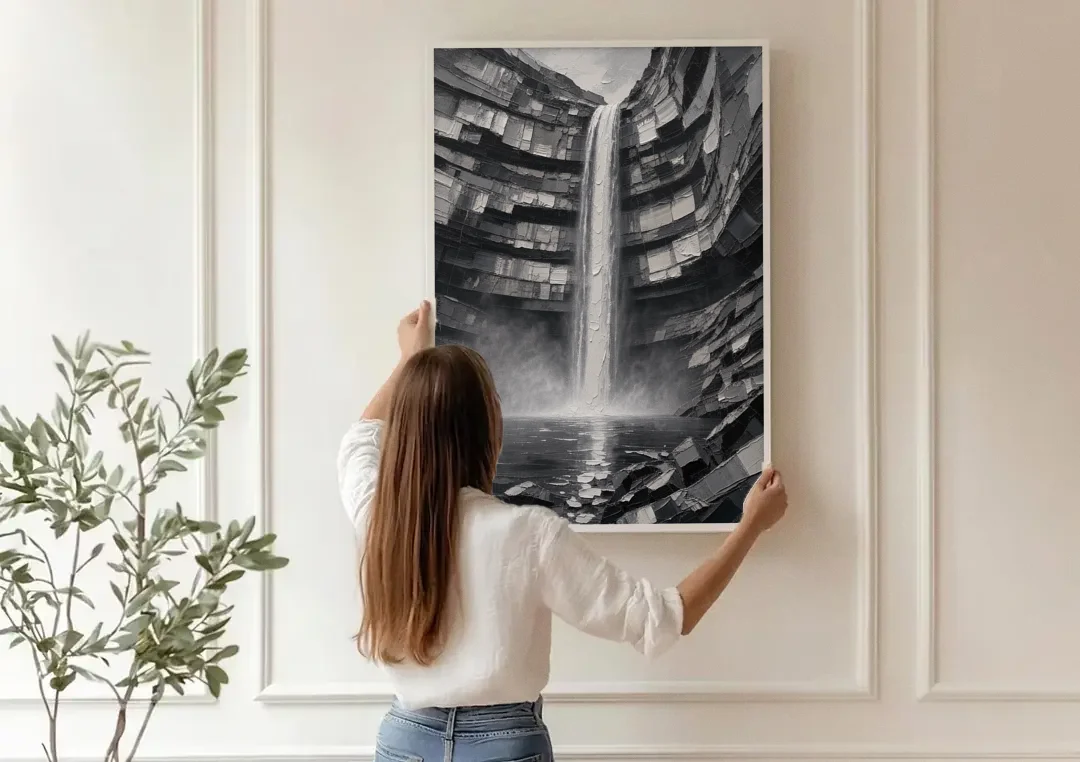 Grayscale Wall Art of a Canyon Waterfall canvas wall art being hung on a paneled wall
