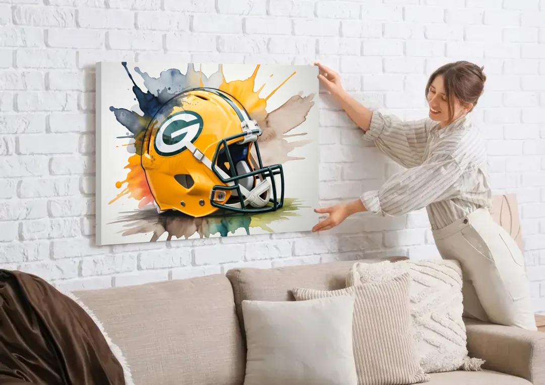 Green Bay Packers Yellow Helmet Watercolor canvas wall art being hung on a white brick wall above a sofa
