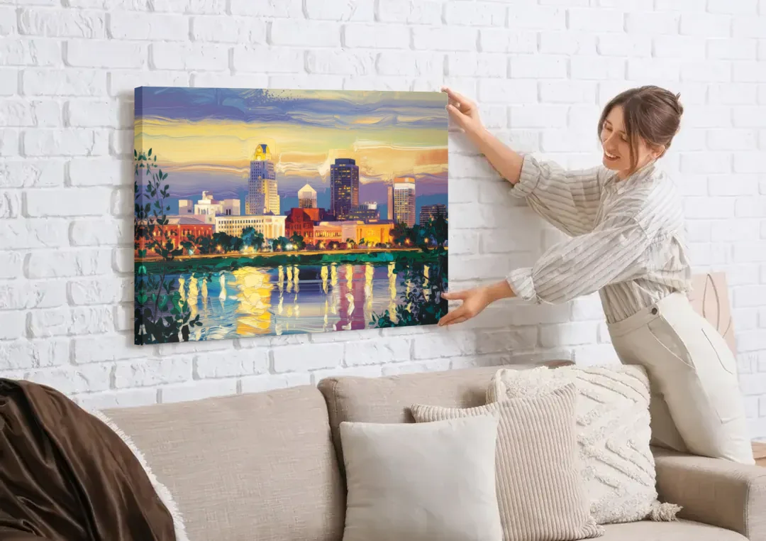 Greensboro Cityscape Panorama canvas wall art being hung on a white brick wall above a sofa