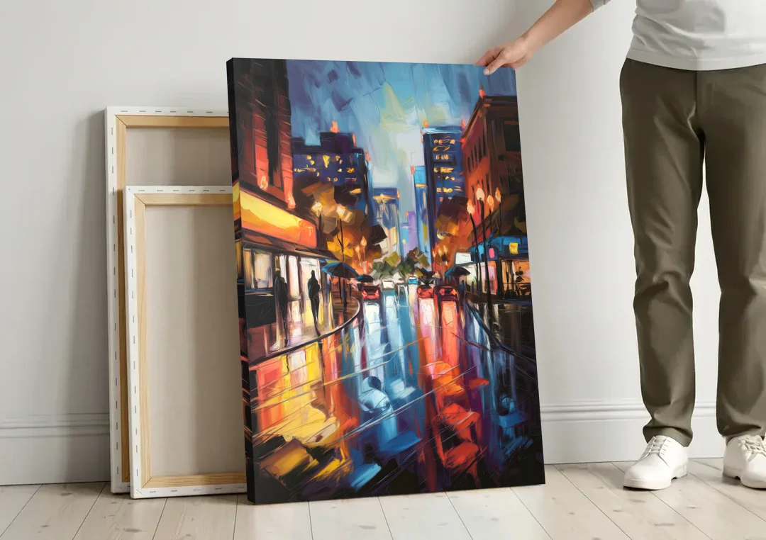 Greenville Night City Lights canvas wall art leaning against a wall next to blank canvases