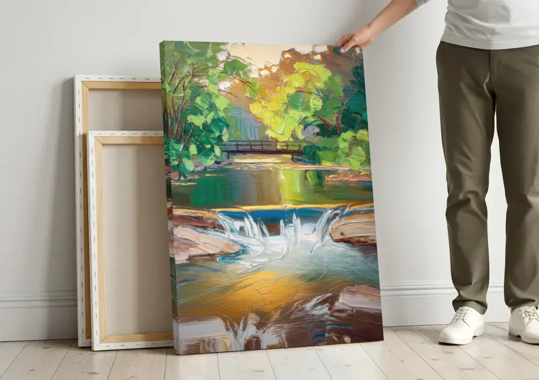 Greenville Reedy River Views canvas wall art leaning against a wall next to blank canvases