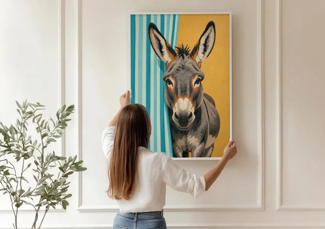 Half Bath Wall Decor with a Curious Donkey canvas wall art being hung on a paneled wall