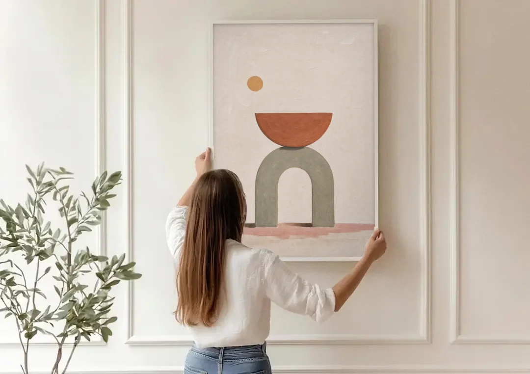 Half Moon Wall Art Balanced on a Sage Arch canvas wall art being hung on a paneled wall