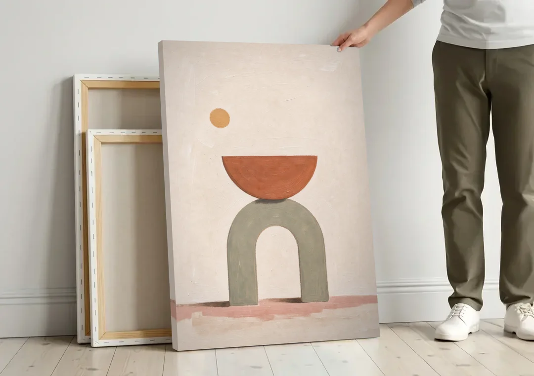Half Moon Wall Art Balanced on a Sage Arch canvas wall art leaning against a wall next to blank canvases