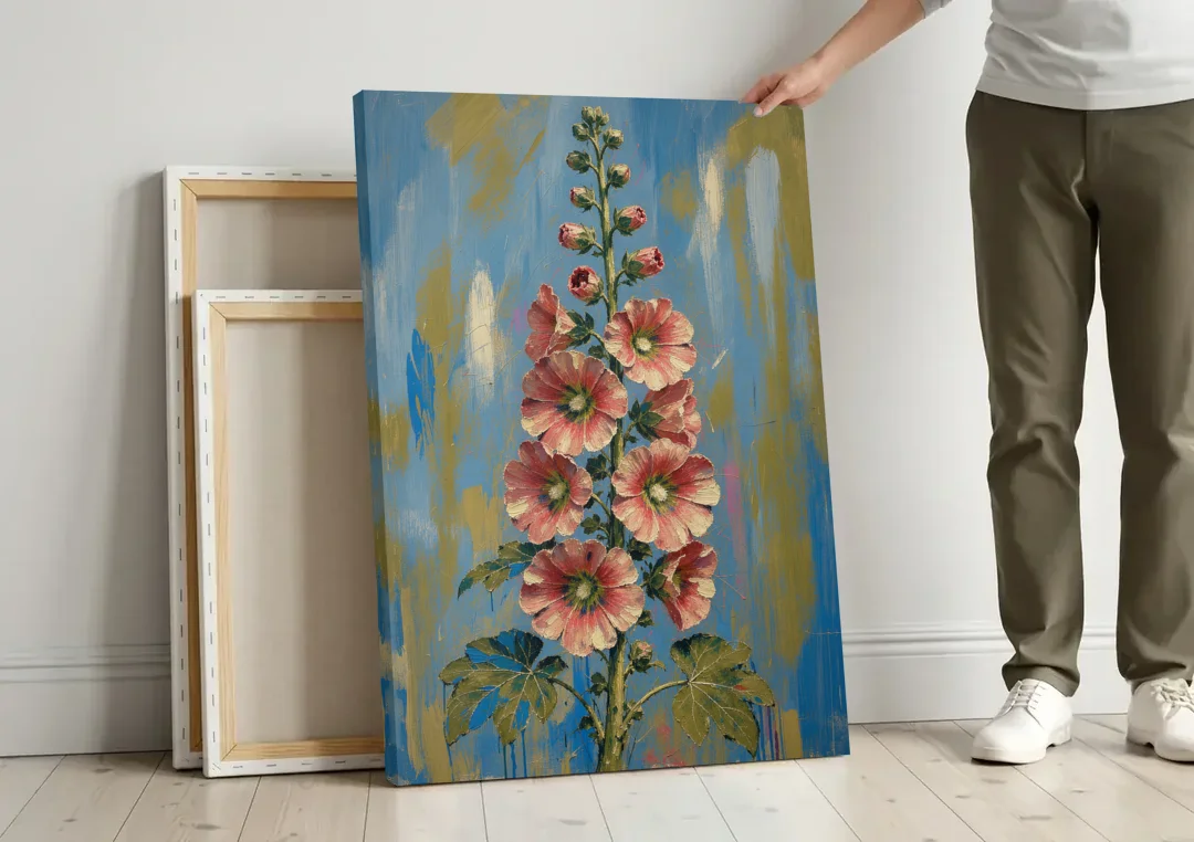 Hand Painted Floral Canvas of a Tall Hollyhock canvas wall art leaning against a wall next to blank canvases
