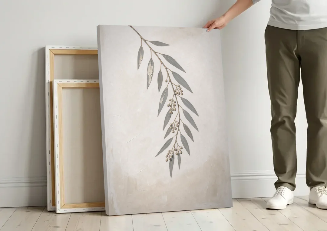 Hanging Eucalyptus Sprig with Seed Clusters canvas wall art leaning against a wall next to blank canvases