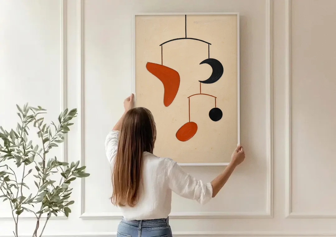 Hanging Mobile of Vermilion and Black Shapes canvas wall art being hung on a paneled wall