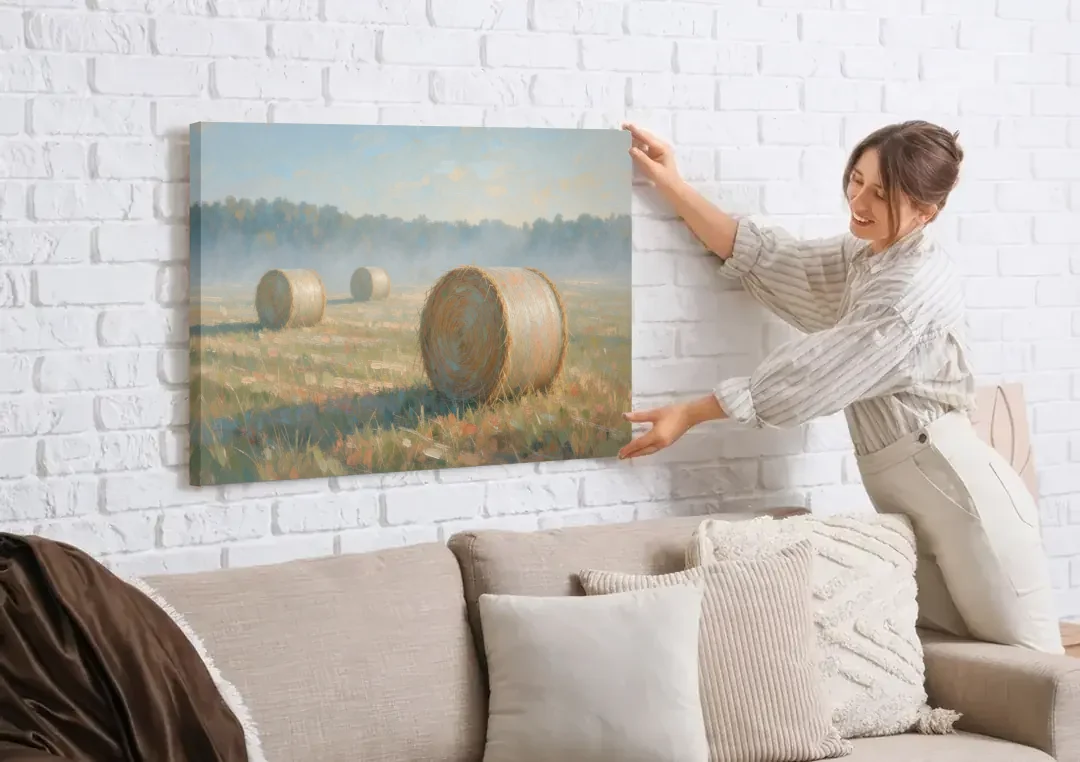 Hay Bales Painting at First Peach Light canvas wall art being hung on a white brick wall above a sofa