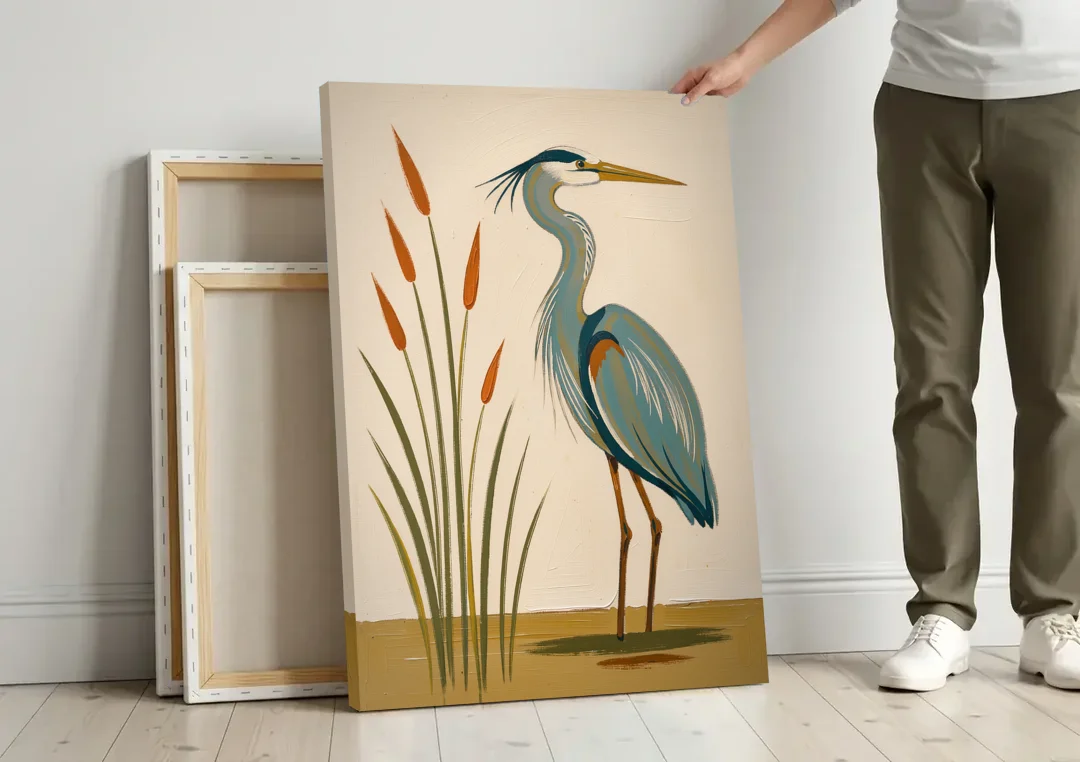 Heron Wall Art of a Blue Heron Among Cattails canvas wall art leaning against a wall next to blank canvases