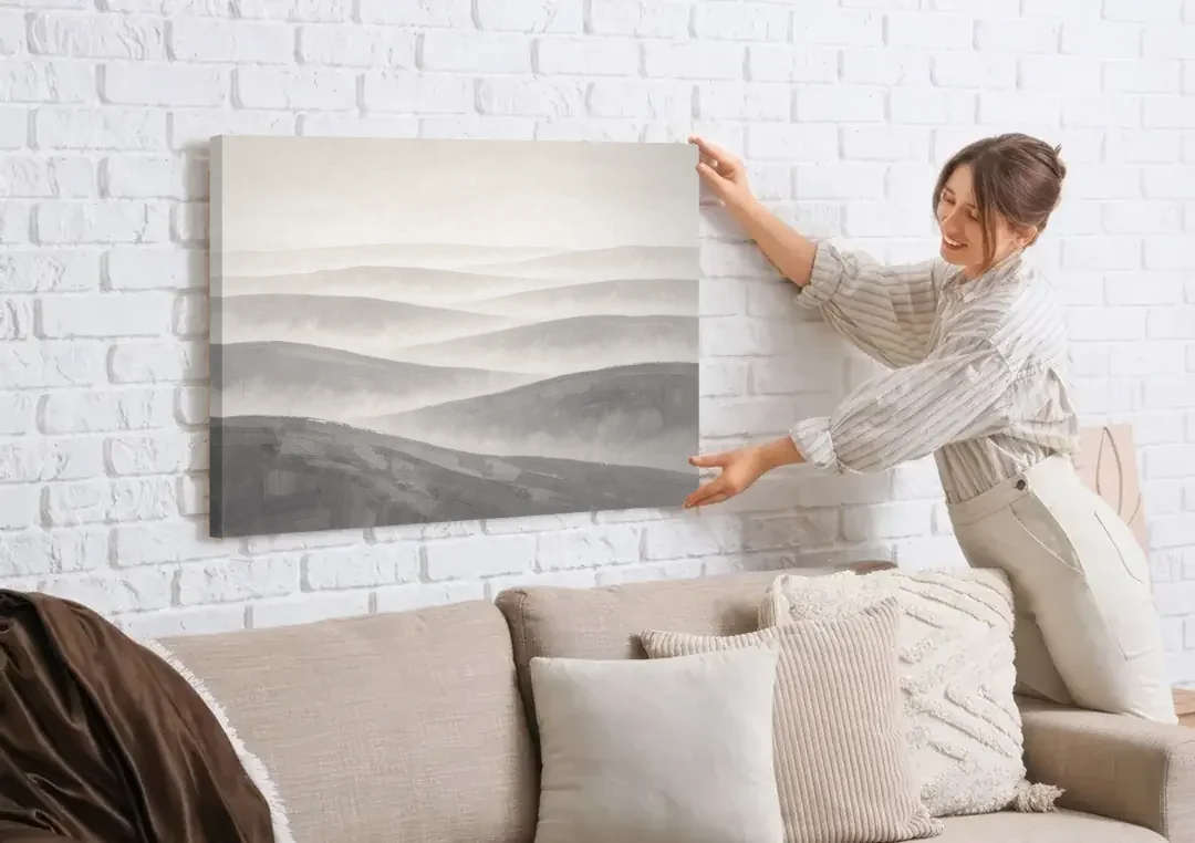 Home Office Wall Decor with Misty Rolling Hills canvas wall art being hung on a white brick wall above a sofa