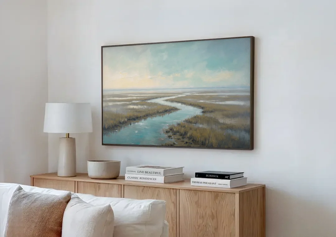 Horizon Wall Art of a Lowcountry Marsh at Dawn canvas wall art above a wooden sideboard next to a sofa
