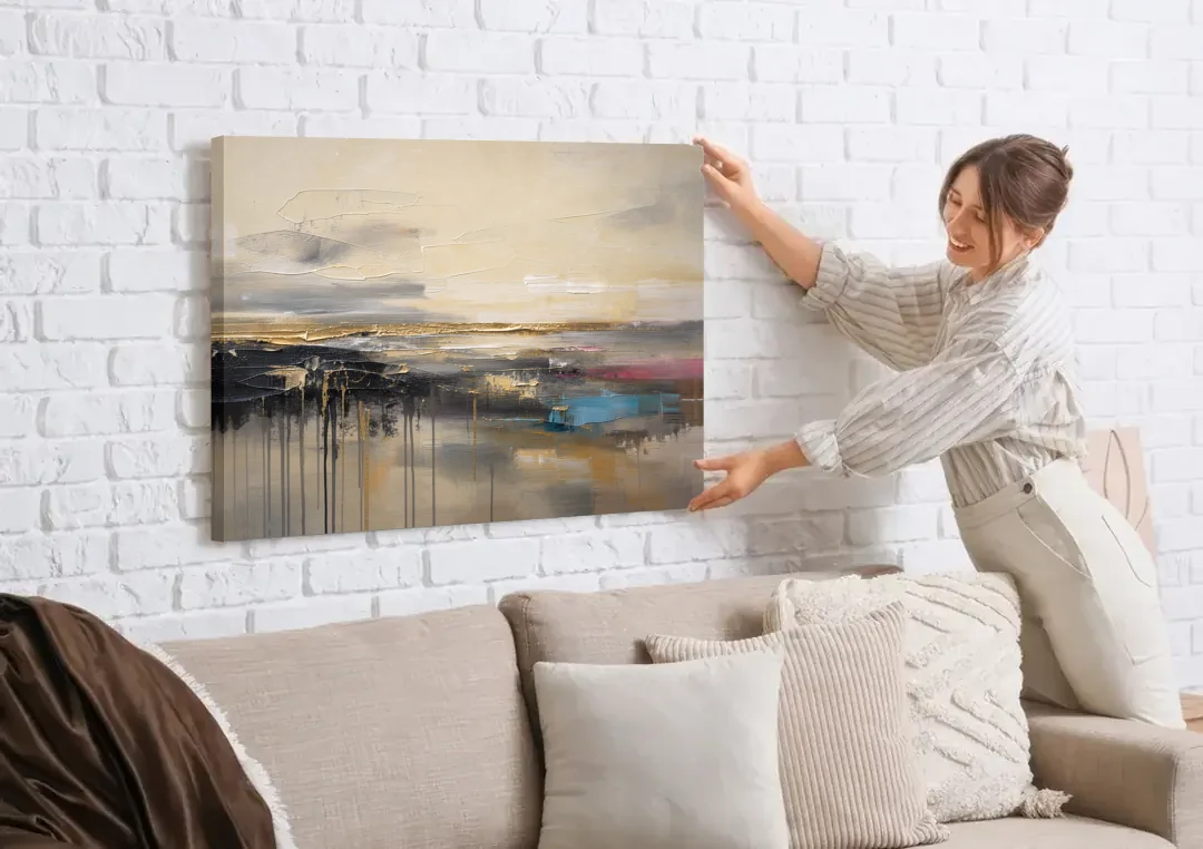 Horizontal Abstract Gold Seam Horizon Over Dripping Earth canvas wall art being hung on a white brick wall above a sofa