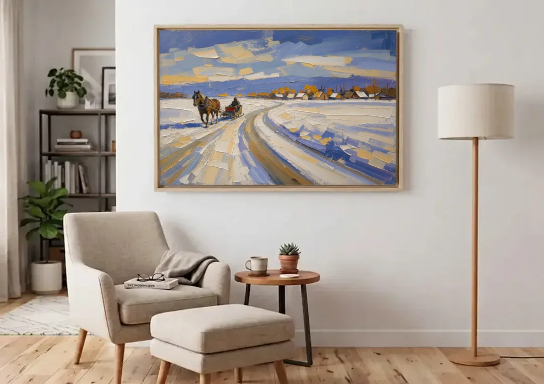 Horse Drawn Sleigh Painting Toward the Village canvas wall art above an armchair in a bright living room