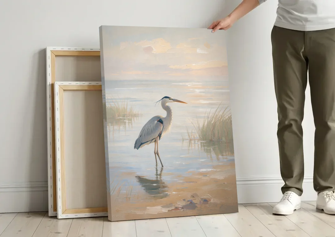 Hotel Room Decor with a Heron in Misty Shallows canvas wall art leaning against a wall next to blank canvases