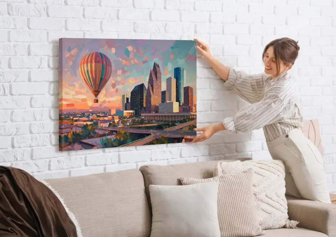 Houston Artistic Flair canvas wall art being hung on a white brick wall above a sofa