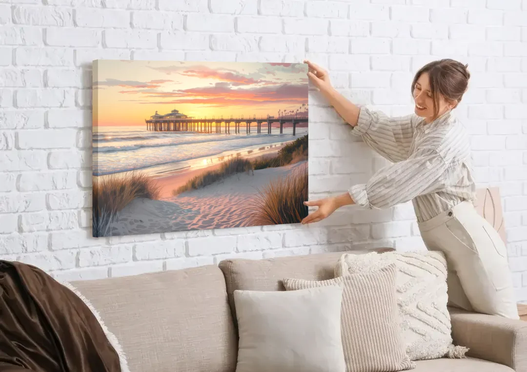 Huntington Beach Coastal Vibes canvas wall art being hung on a white brick wall above a sofa