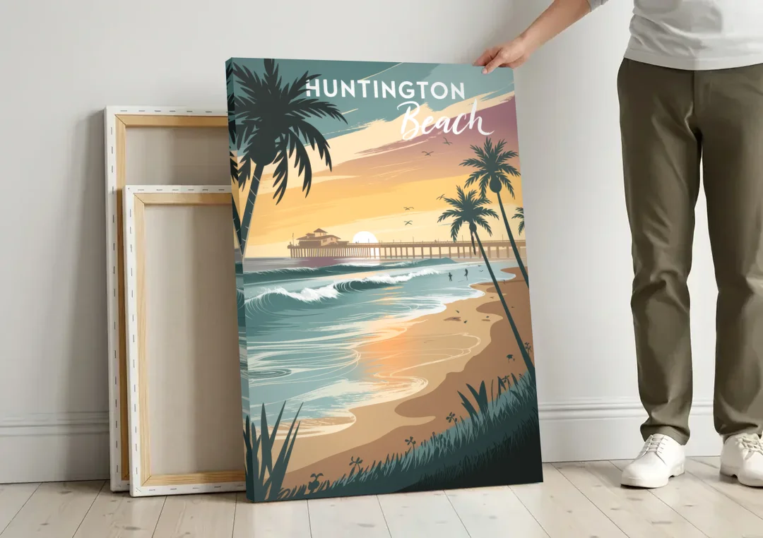 Huntington Beach Pacific Coast canvas wall art leaning against a wall next to blank canvases