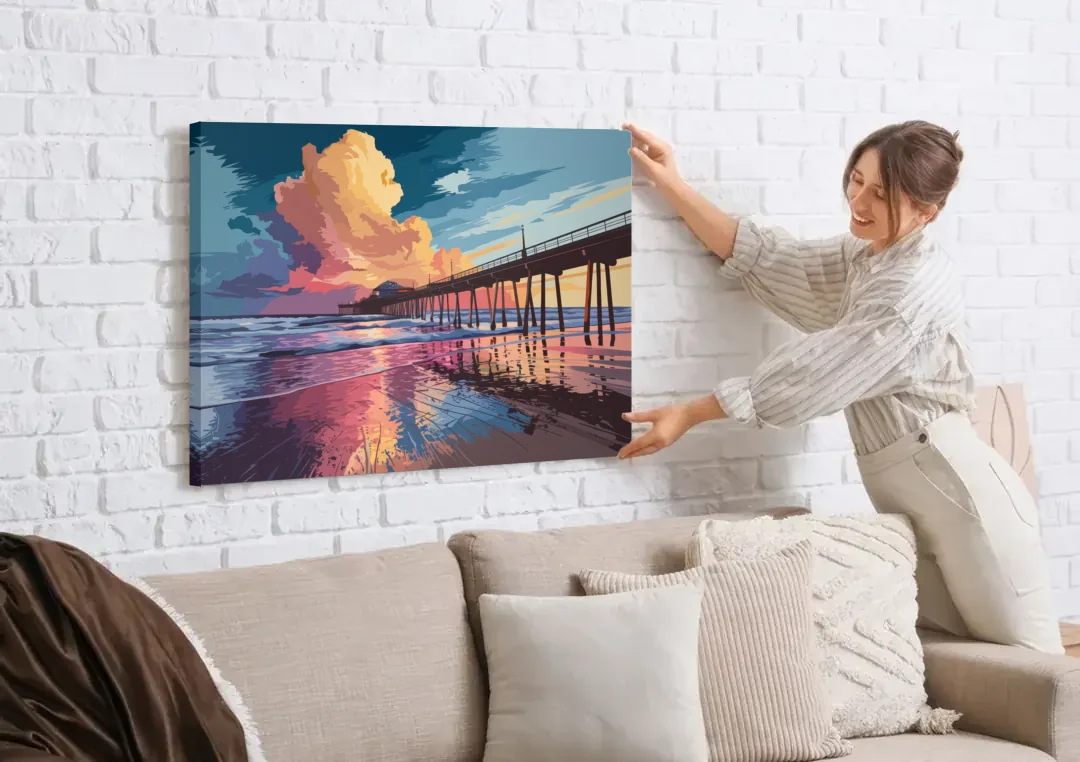 Huntington Beach Sunrise Views canvas wall art being hung on a white brick wall above a sofa