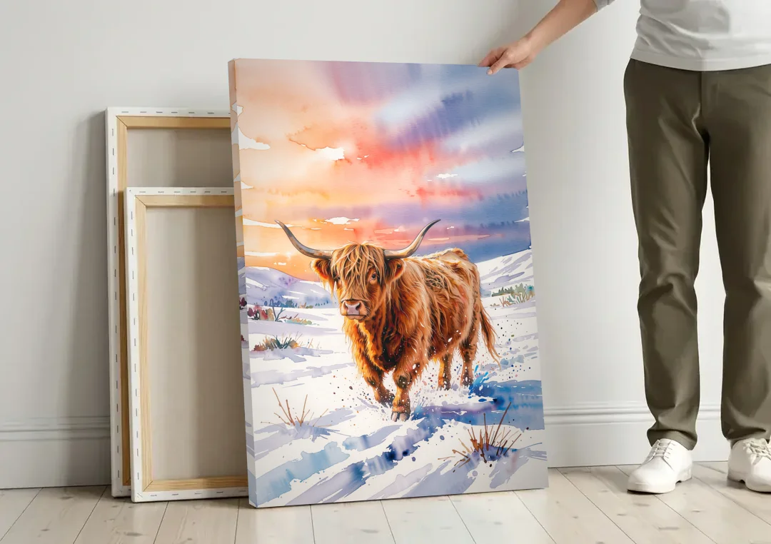 Iconic Highland Cow in Snow canvas wall art leaning against a wall next to blank canvases