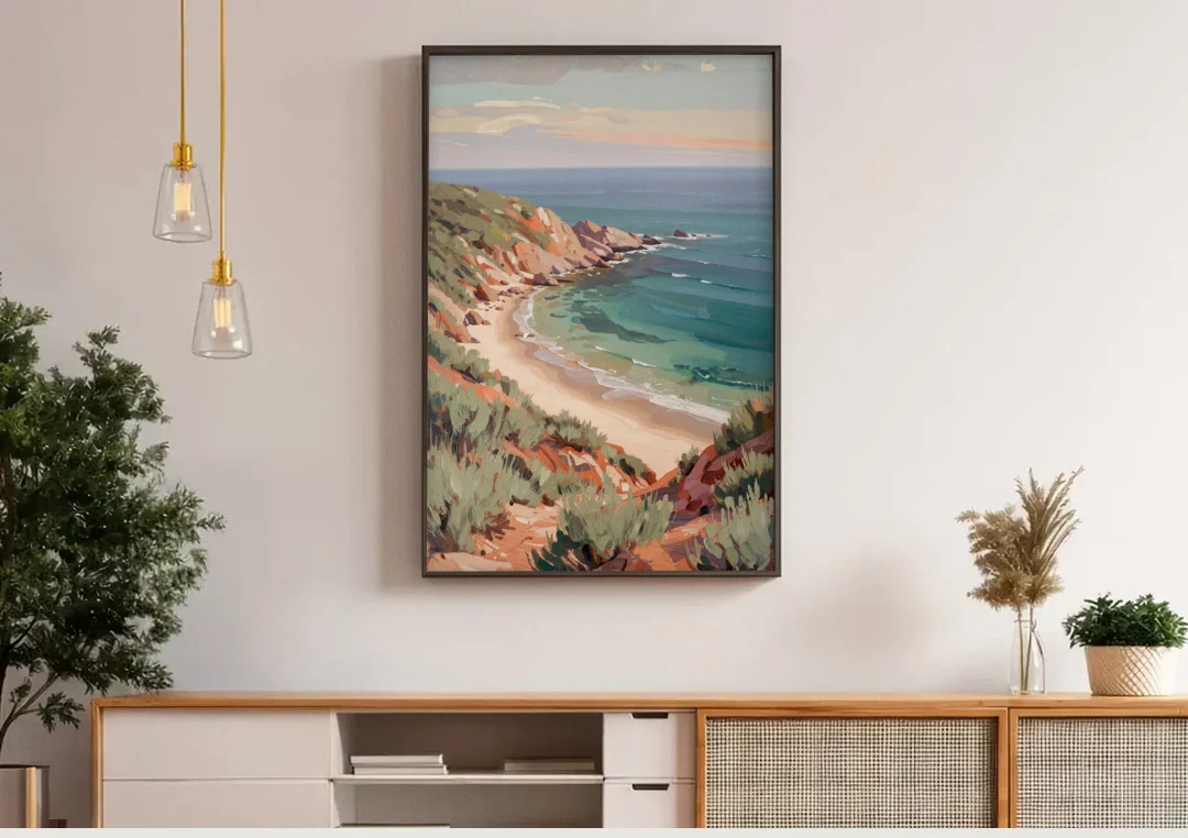 Impressionist Beach Painting of a Clifftop Cove canvas wall art above a wooden sideboard under pendant lights