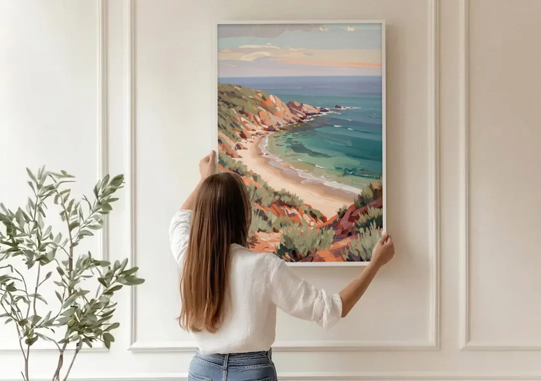 Impressionist Beach Painting of a Clifftop Cove canvas wall art being hung on a paneled wall
