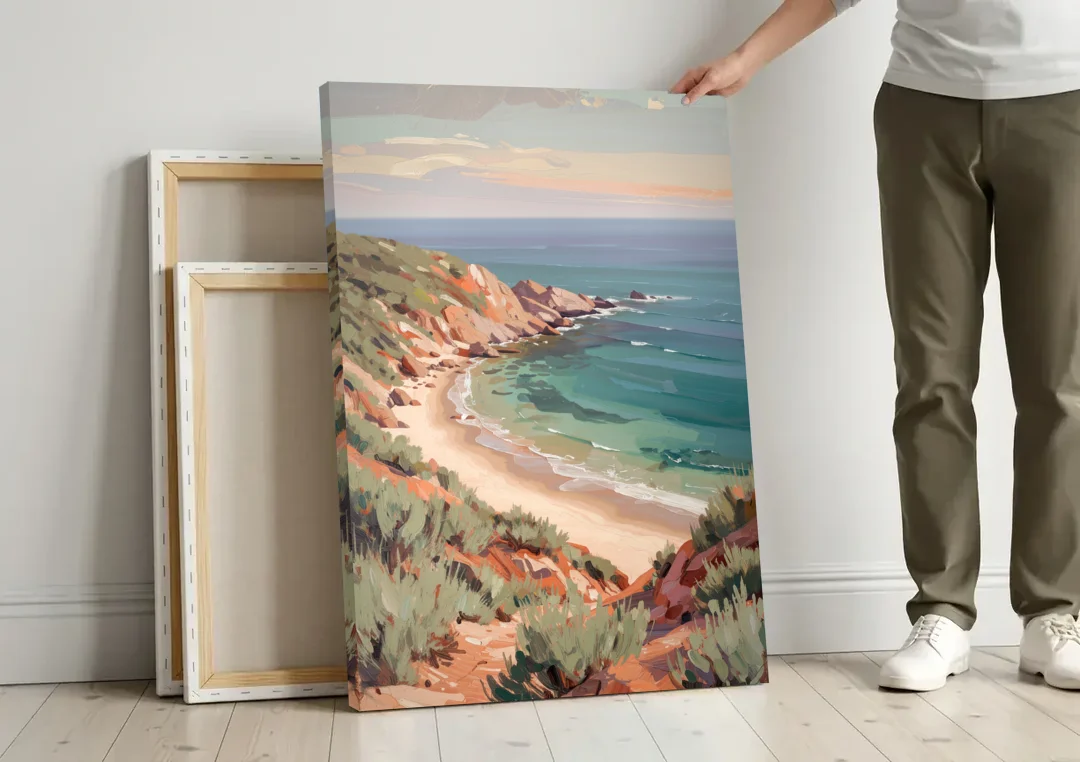 Impressionist Beach Painting of a Clifftop Cove canvas wall art leaning against a wall next to blank canvases