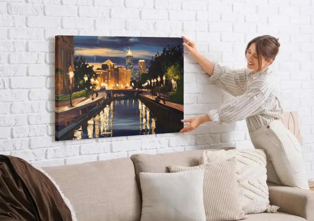 Indianapolis Canal Walk View canvas wall art being hung on a white brick wall above a sofa