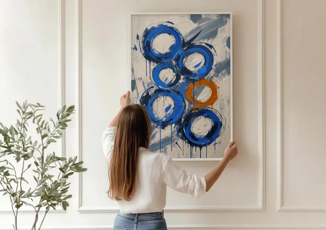 Indigo Wall Art with Five Dripping Rings canvas wall art being hung on a paneled wall