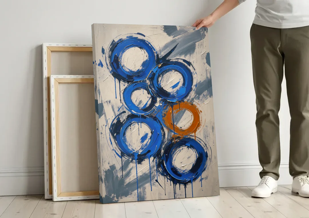 Indigo Wall Art with Five Dripping Rings canvas wall art leaning against a wall next to blank canvases