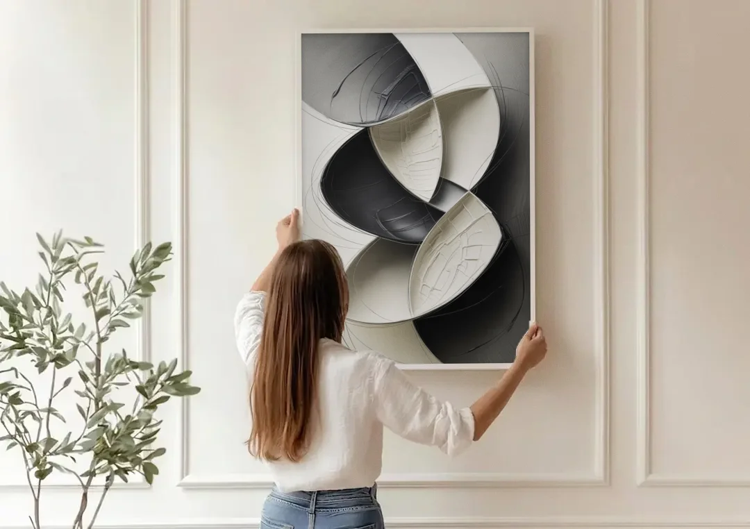 Intertwined Geometric Sophistication Black and White Abstract canvas wall art being hung on a paneled wall