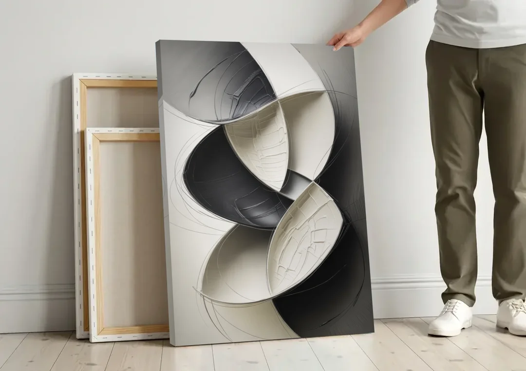 Intertwined Geometric Sophistication Black and White Abstract canvas wall art leaning against a wall next to blank canvases