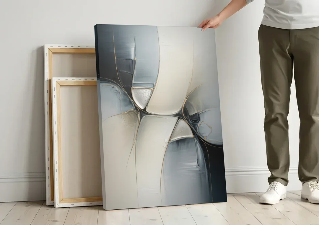 Intricate Harmony Grey and White Abstract canvas wall art leaning against a wall next to blank canvases