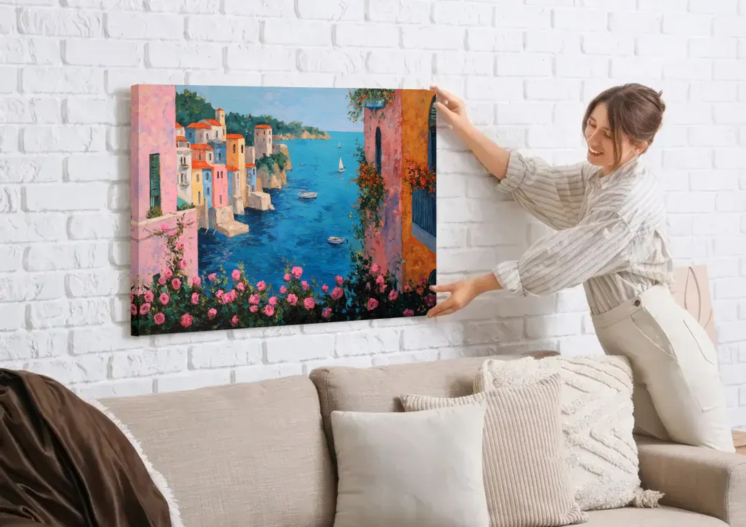 Italian Painting of a Village in Roses canvas wall art being hung on a white brick wall above a sofa
