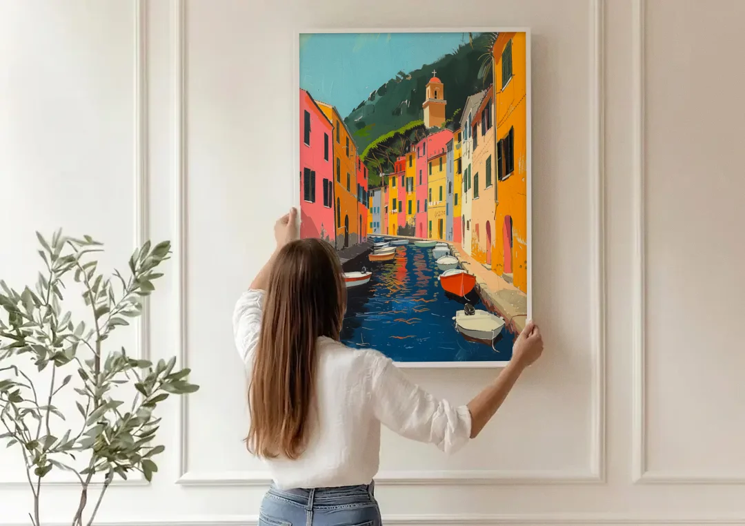 Italy Painting of a Canal with Boats canvas wall art being hung on a paneled wall