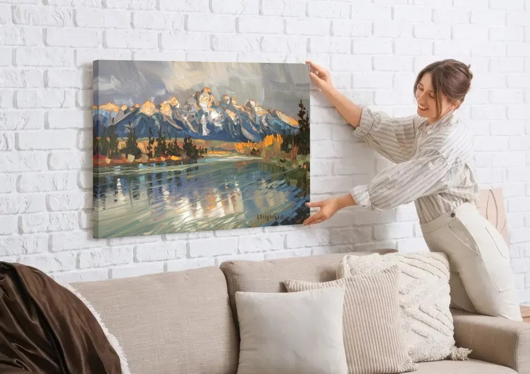 Jackson Hole River Reflection canvas wall art being hung on a white brick wall above a sofa