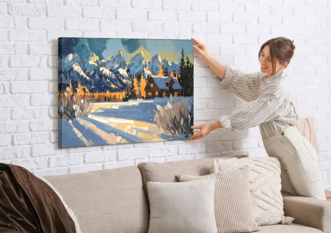 Jackson Hole Winter Wonderland canvas wall art being hung on a white brick wall above a sofa