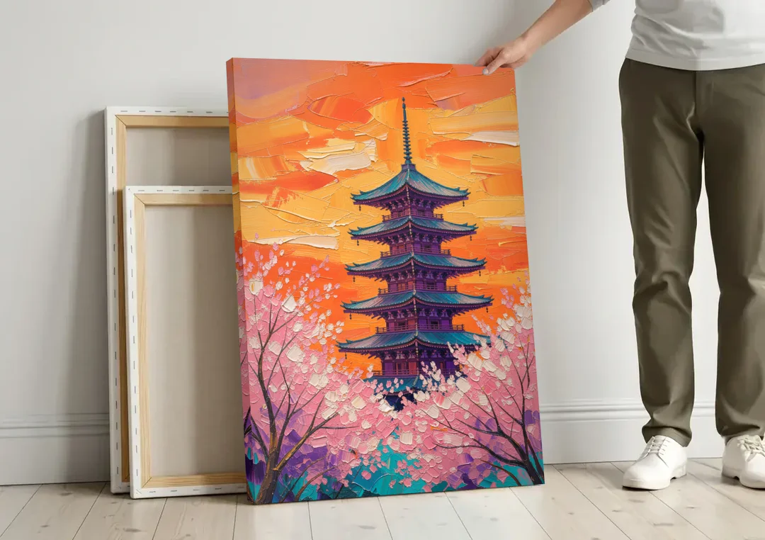 Japanese Cherry Blossom Painting with Pagoda at Sunset canvas wall art leaning against a wall next to blank canvases
