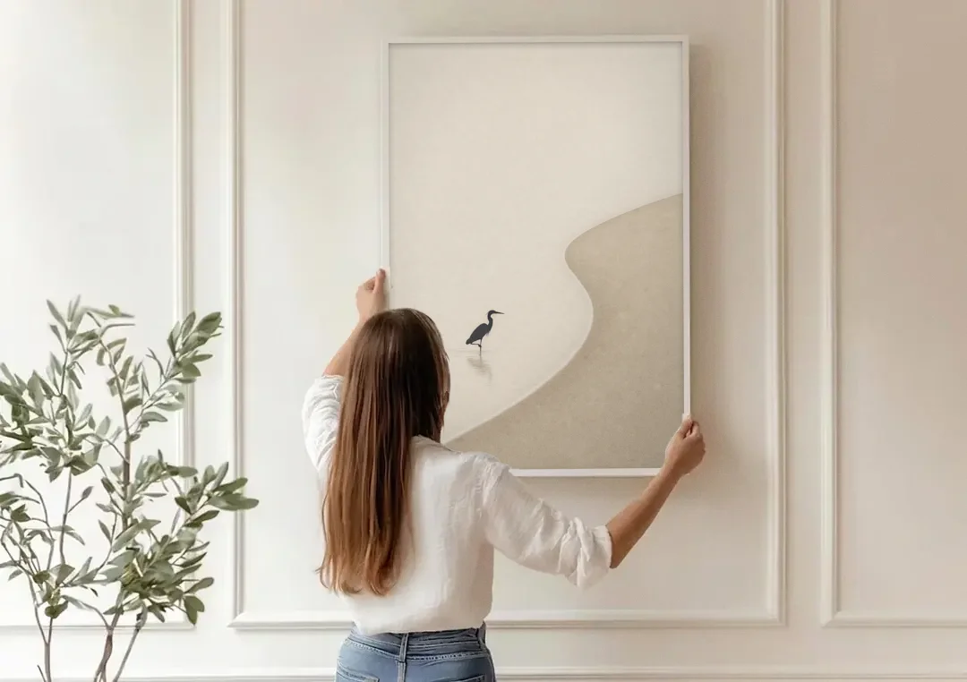 Japanese Minimalist Art of a Heron in the Shallows canvas wall art being hung on a paneled wall